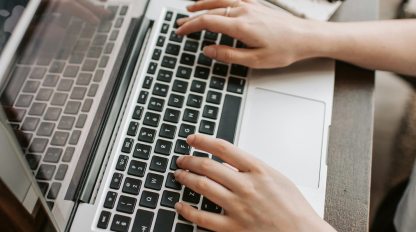 Worker Typing On Laptop