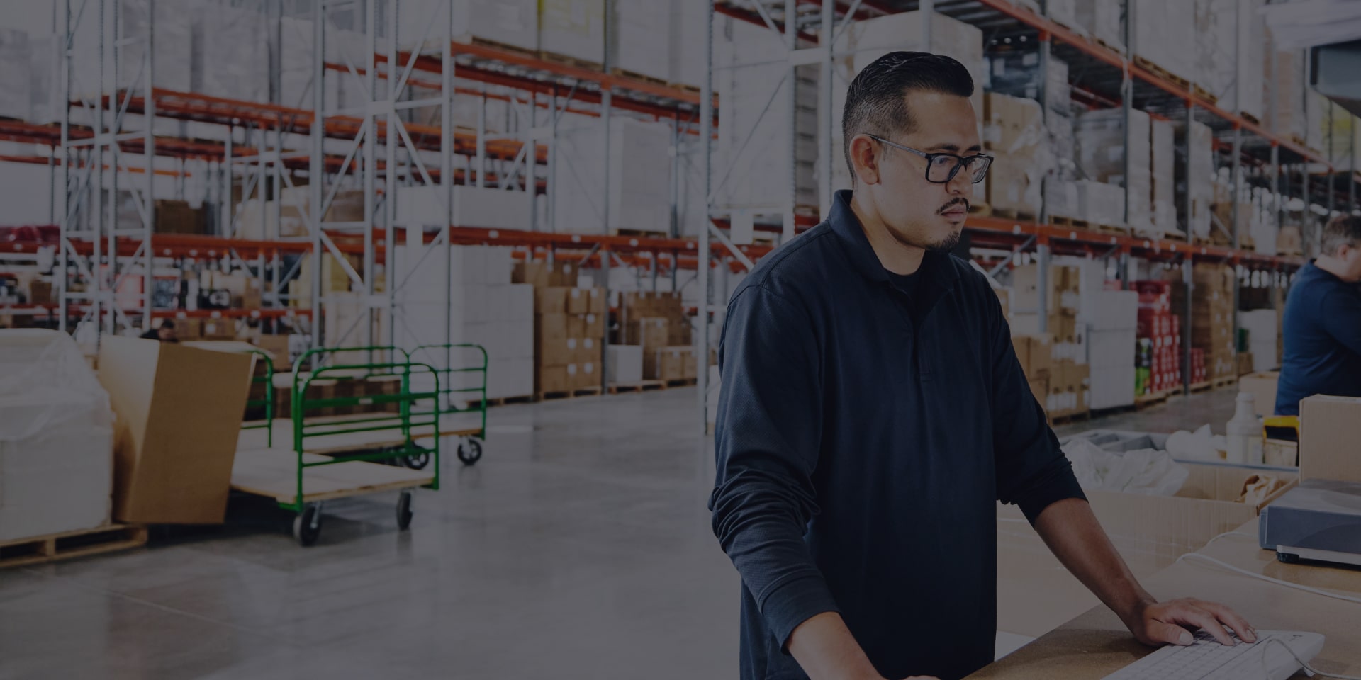 Worker In A Warehouse Working On Computer