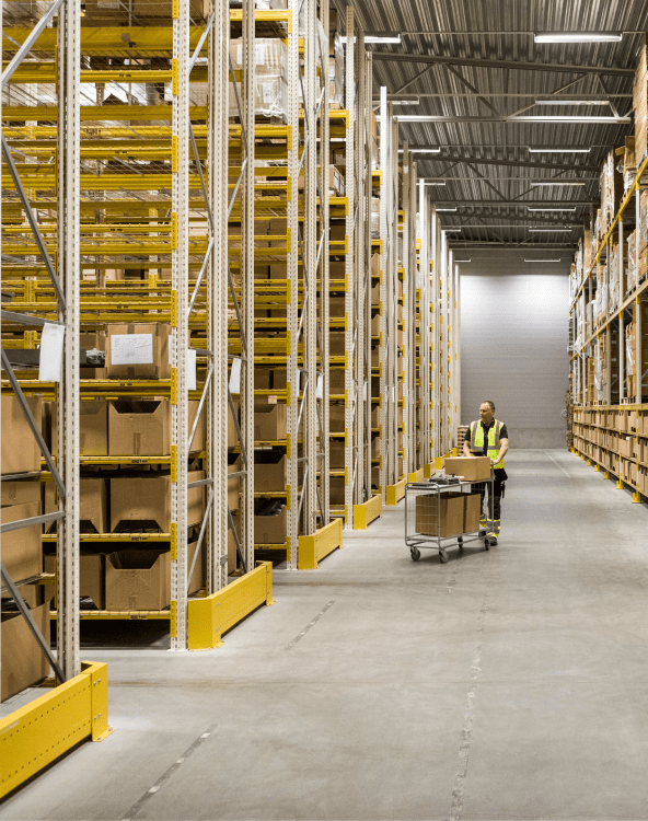 Man Walking With Cargoes In Warehouse