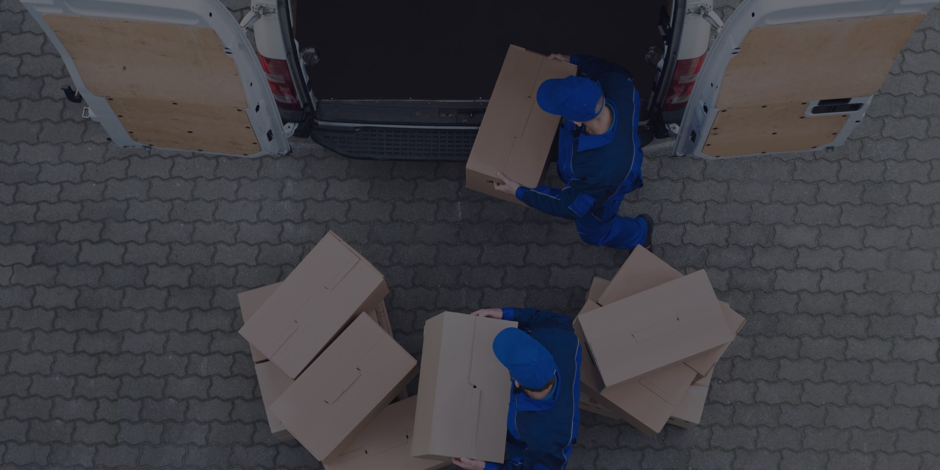 Two Men Transferring Cargos To A Van